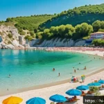 Home 18 알바니아 날씨 및 기후 - A vibrant summer beach scene in Albania featuring golden sandy shores and crystal-clear turquoise wa...